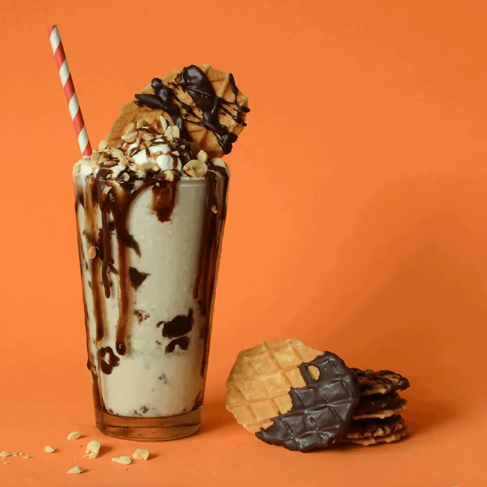 An ice cream shake with chocolate covered cookies.