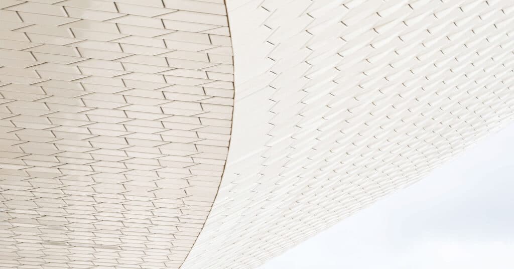 A white sculpture with a repeating geometric pattern