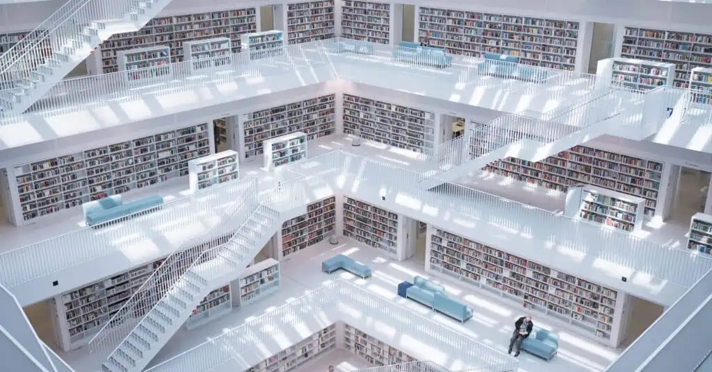 A clean and modern library with several levels and many stairs.