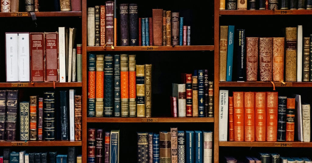 photo of a library interior, potentially rows of organized shelves or books to symbolize structured data.