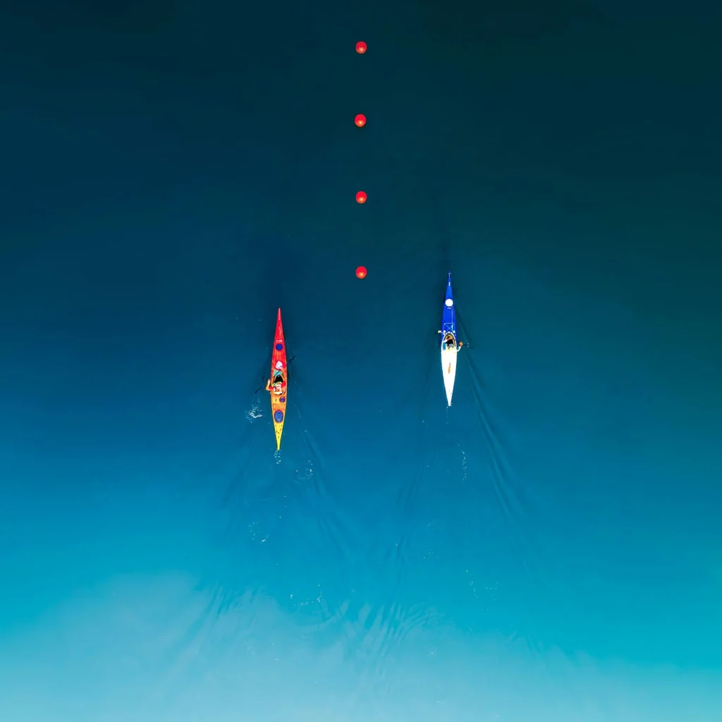 Two boats race in a lake.