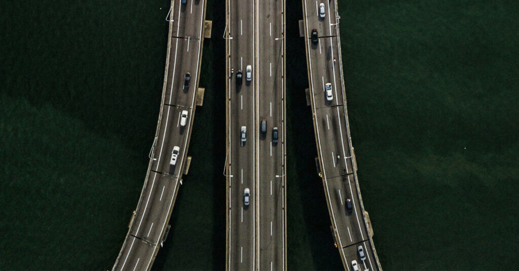 An eight-lane interstate separated into three prongs as viewed from above.